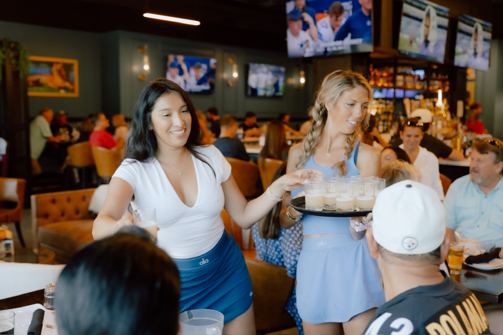 Shot trays being delivered to a packed Clubhouse