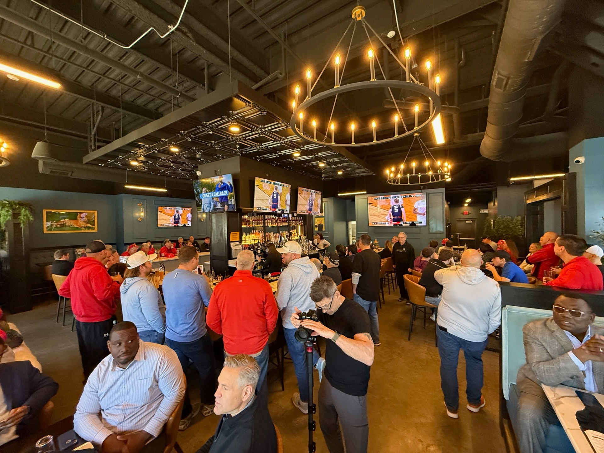 Crowd around the main bar at The Clubhouse during a watch party