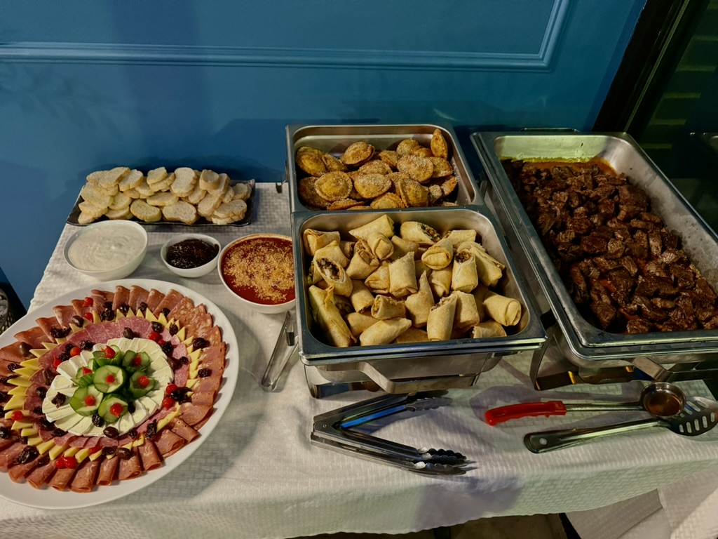 Graduation party catering trays — charcuterie, ravioli, egg rolls, and steak